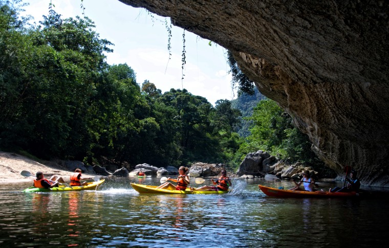 Kayaking Kuching tour group emerge from the caves.