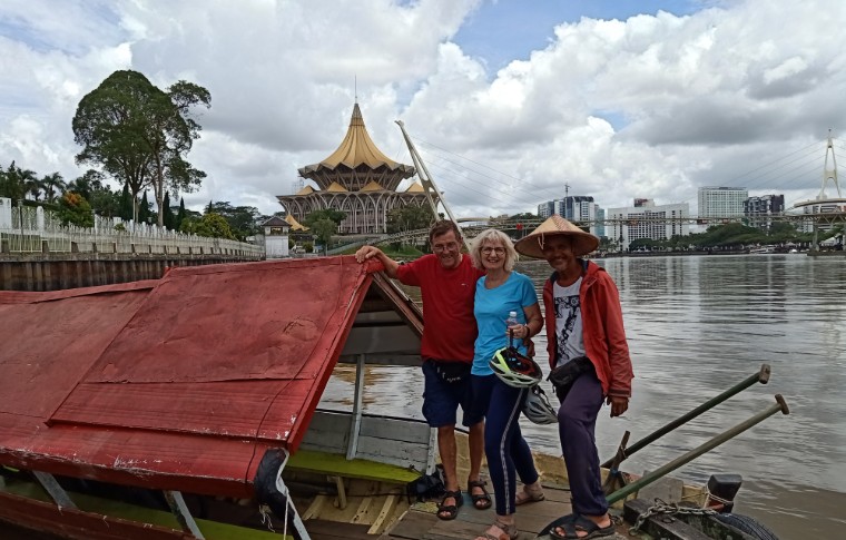 Guests pose for a picture with their guide on the Sarawak River sampan cruise.
