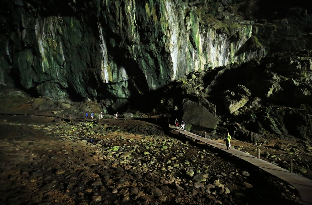 The Deer Cave passage, Mulu National Park, towers over visitors. Part of Niah and Mulu Heritage sites article