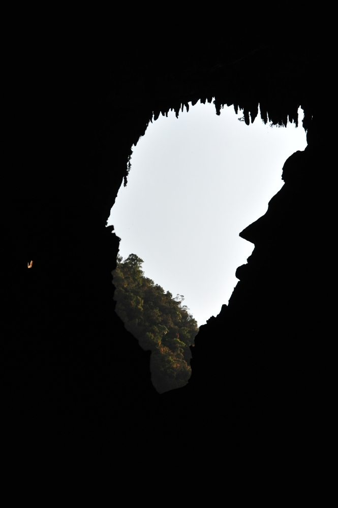 Cave formation resembling Abraham Lincoln's profile seen against the light at Deer Cave entrance